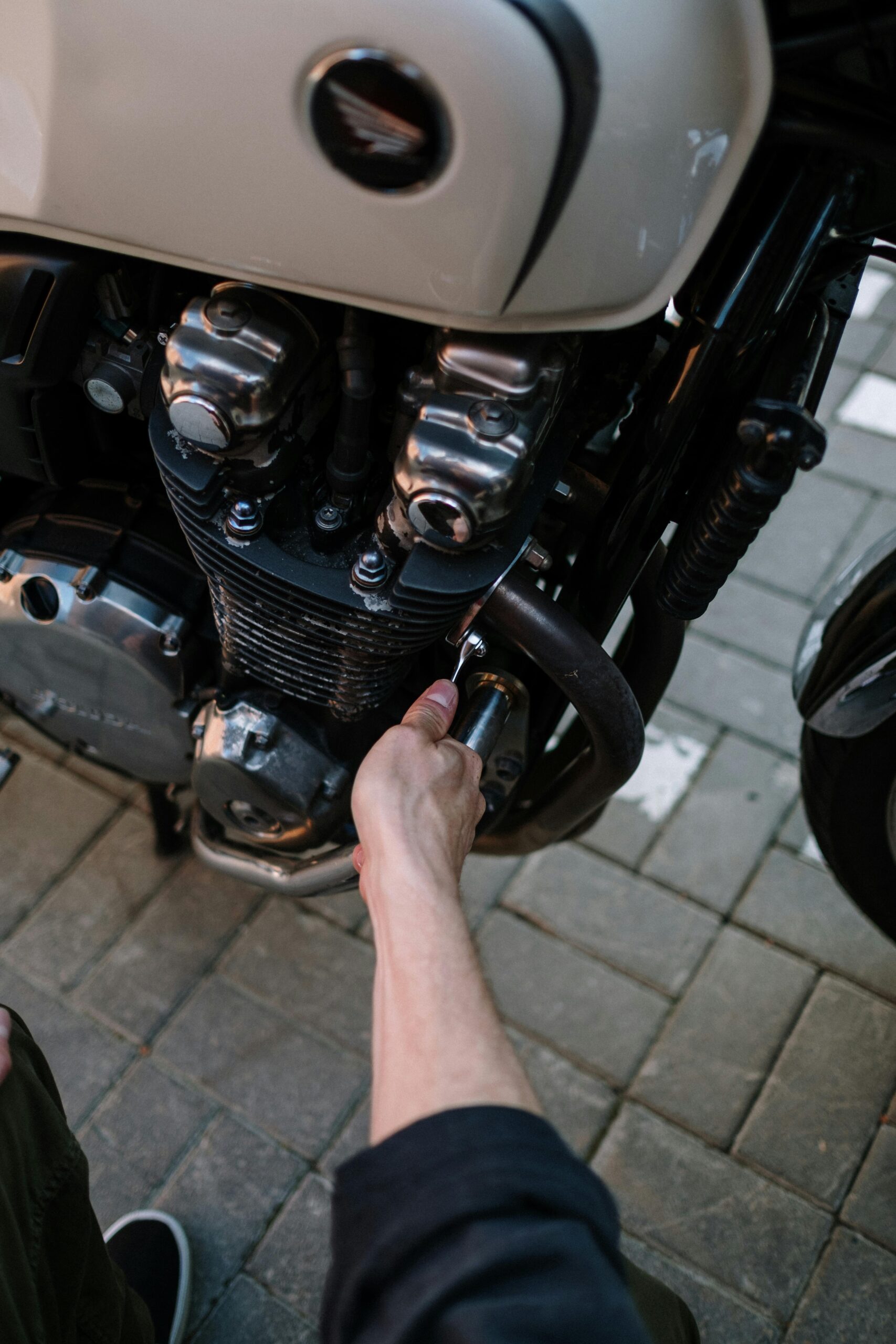 Person Fixing Black Motorcycle